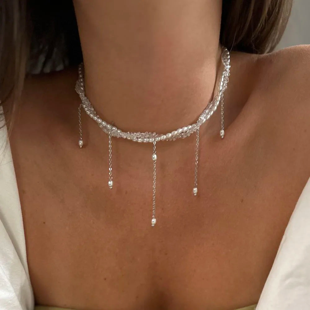 A delicate silver choker necklace with sparkling crystals and dangling pearl beads in womens accessories collection