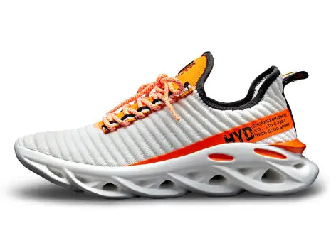 Side view of a white knit running shoe with orange accents and an open-cutout sole