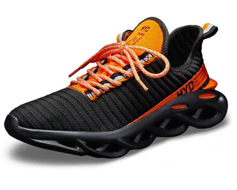 Black knit running shoe with orange accents, laces and a sculpted black sole