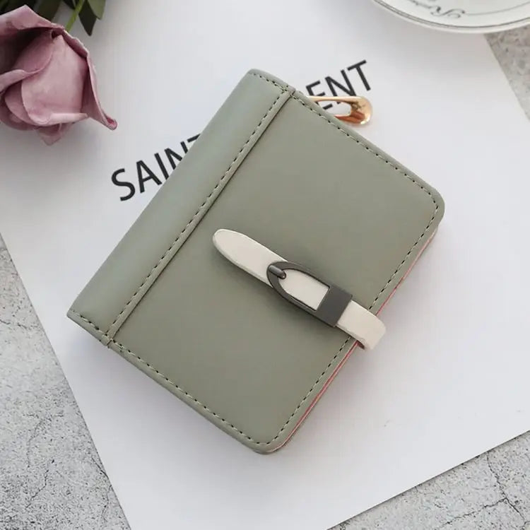 Classic Morandi folding card wallet in sleek sage green with white belt buckle closure and subtle stitching details
