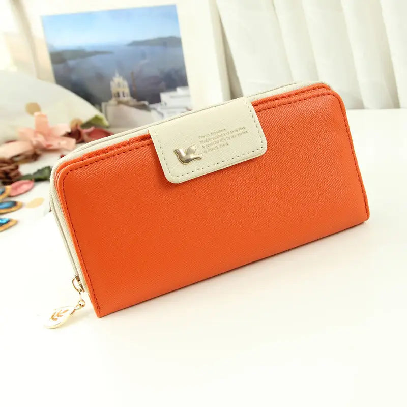 Orange textured designer wallet with white flap and silver bird emblem engraved text coin purse phone pouch wallet image