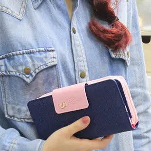 Navy blue and pink two-tone designer wallet image with small gold bird emblem on flap for coin purse phone pouch