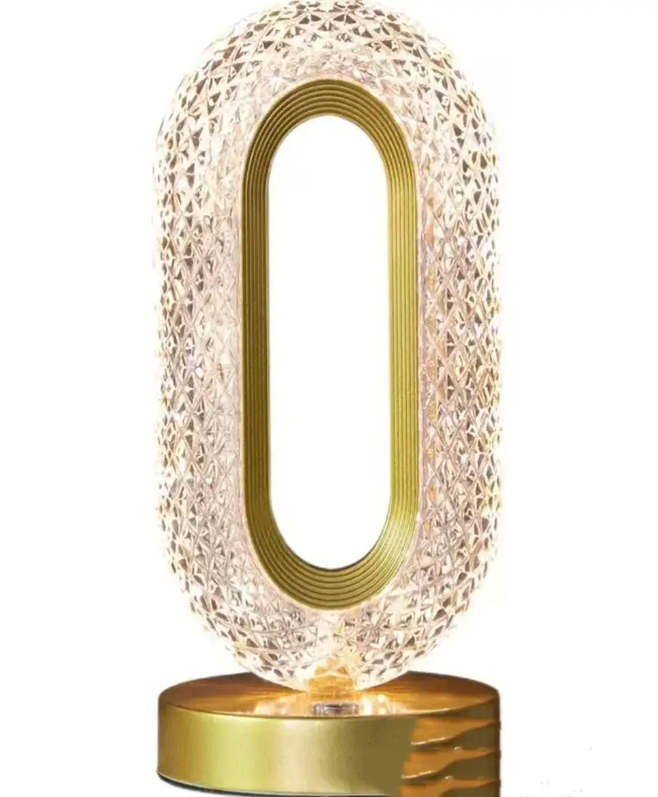 Crystal touch desk lamp with gold-toned metal frame and faceted crystal body diffusing warm light for luxury decor