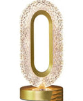 Crystal touch desk lamp with gold-toned frame and clear faceted crystal body diffusing warm light for luxury decor