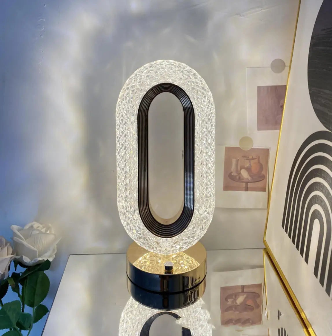 A crystal touch desk lamp with a sparkling crystal exterior, black inner ring, and polished gold base for light luxury decor