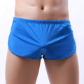 Bright blue form-fitting men’s swim trunks with stretchy elastic waistband and flat waist wigth for sport and fitness use