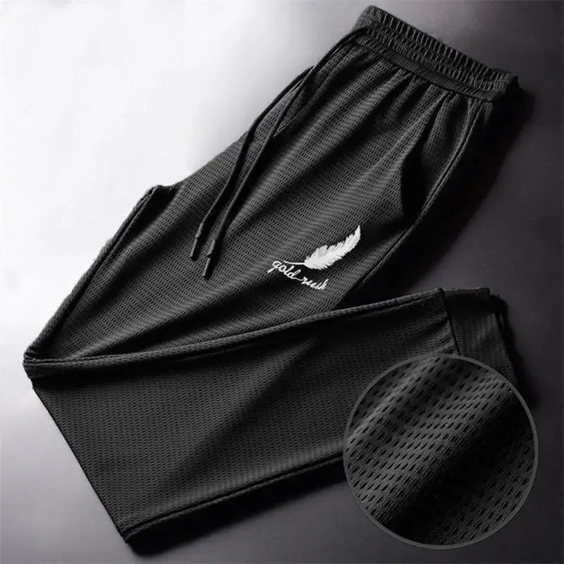 Black mesh outdoor wolf pants featuring white feather and gold rush embroidery on the thigh by R&z