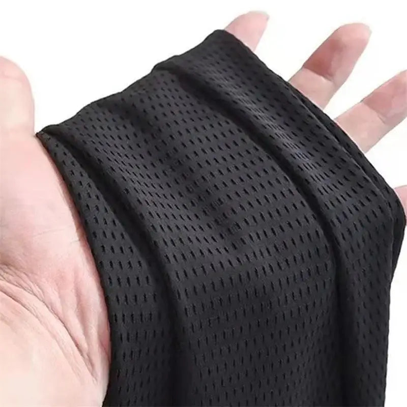 Black mesh fabric wristband with breathable perforated texture for outdoor wolf pants accessory use