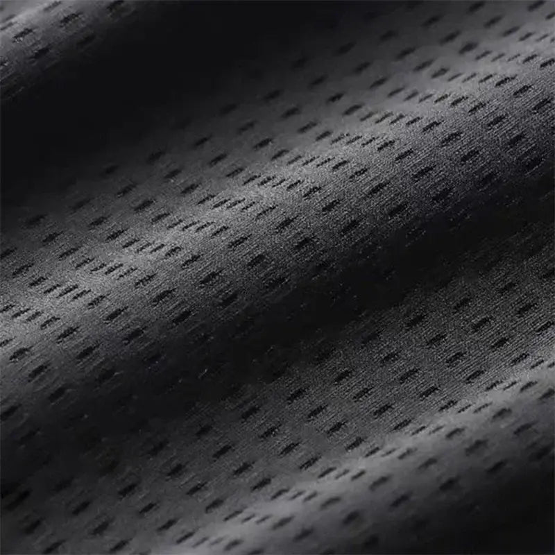 Black perforated mesh fabric with breathable textured weave on r&z outdoor wolf pants for active outdoor use