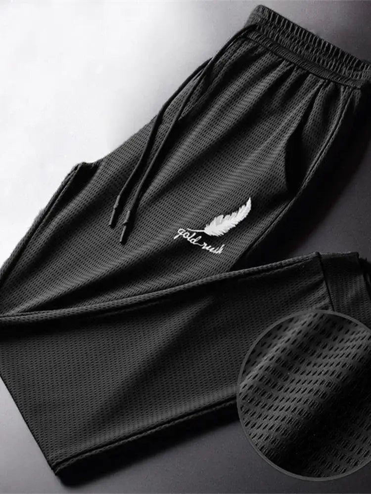 Black mesh outdoor wolf pants with white feather and gold rush embroidery on the thigh by R&z