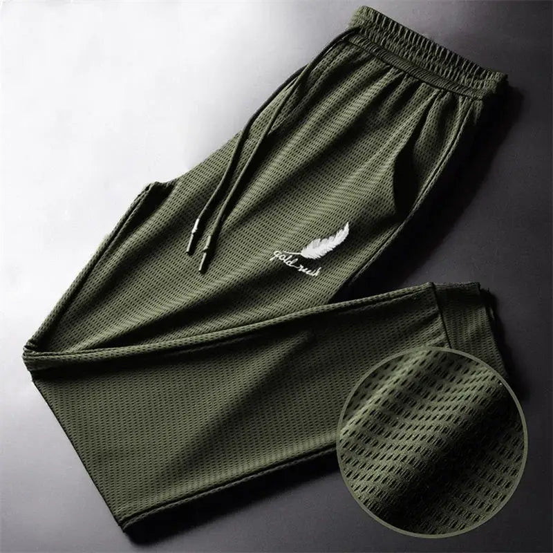 Olive green mesh outdoor wolf pants with white feather and fall rush embroidery on the thigh