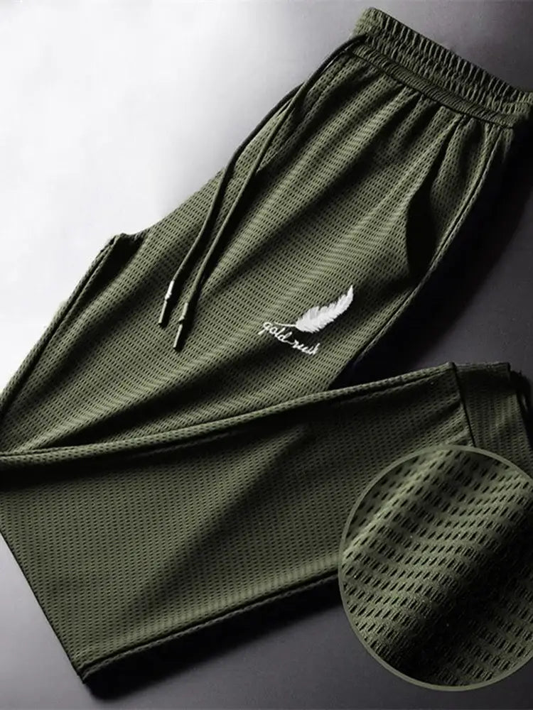 Olive green mesh outdoor wolf pants with white feather and fall rush embroidery on thigh for active wear