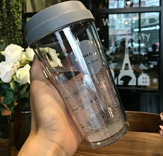 Clear plastic double coffee cup by r z with gray lid and coffee city sticker for portable double coffee use
