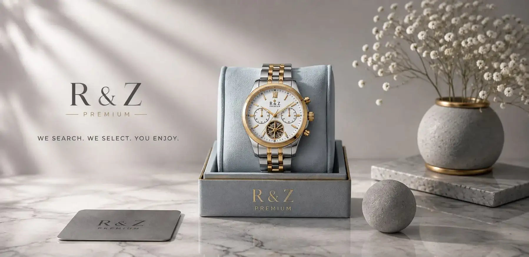 A sleek r&z premium chronograph watch with a two-tone gold and silver stainless steel case, white dial featuring three subdials and a visible gearwork design.
