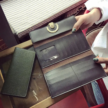 Dark brown leather women’s wallet and clutch handbag with a gold crescent clasp and multiple card slots in horizontal square shape