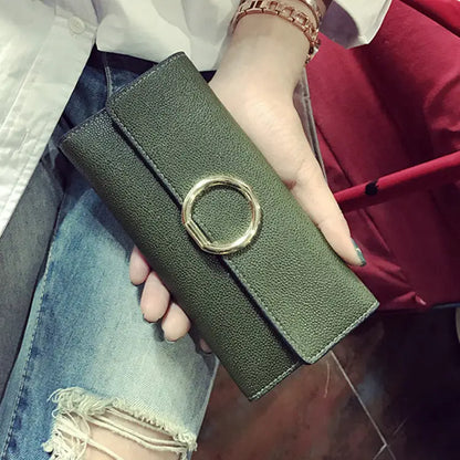Olive green textured leather women’s wallet and clutch handbag with a horizontal square shape and gold-toned circular clasp